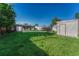 Lush backyard with green grass and mature trees, ideal for outdoor activities and relaxation at 3090 W Longfellow Pl, Denver, CO 80221