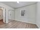 Bedroom with wood floors, mirrored closet, with a window to bring in natural light at 3090 W Longfellow Pl, Denver, CO 80221