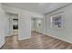 Bedroom with wood-look flooring, a mirrored closet, and access to an ensuite bathroom at 3090 W Longfellow Pl, Denver, CO 80221