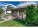 Charming home with a well-manicured lawn and inviting front porch, perfect for relaxing outdoors at 3090 W Longfellow Pl, Denver, CO 80221