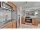 Well-equipped kitchen with stainless steel appliances, granite countertops, and ample cabinet space at 3090 W Longfellow Pl, Denver, CO 80221