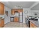 Well-equipped kitchen with stainless steel appliances, granite countertops, and ample cabinet space at 3090 W Longfellow Pl, Denver, CO 80221