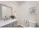 Stylish powder room features gray vanity, sleek faucet, decorative mirror, and neutral decor at 9383 Cobblecrest Dr, Highlands Ranch, CO 80126