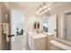 Bright bathroom featuring a large mirror and a doorway that flows to a hall at 9383 Cobblecrest Dr, Highlands Ranch, CO 80126