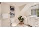 Bathroom with a white cabinet, marble countertop, decorations, and art at 9383 Cobblecrest Dr, Highlands Ranch, CO 80126