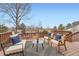 Outdoor deck features stylish seating, including chairs and a bench, arranged around a small table, with lovely neighborhood views at 9383 Cobblecrest Dr, Highlands Ranch, CO 80126