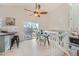 Bright dining area with a glass table, modern chairs, and access to a deck at 9383 Cobblecrest Dr, Highlands Ranch, CO 80126