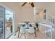 Bright dining area with hardwood floors, a glass table and chairs, and sliding doors to the deck at 9383 Cobblecrest Dr, Highlands Ranch, CO 80126