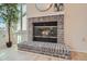 Brick fireplace with glass door and hearth, adding warmth and charm to the living space at 9383 Cobblecrest Dr, Highlands Ranch, CO 80126