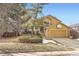 Inviting mustard home with a two-car garage, landscaped front yard and a basketball hoop above the garage at 9383 Cobblecrest Dr, Highlands Ranch, CO 80126