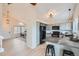 Bright kitchen features an island with barstool seating, and transitions seamlessly into a cozy living area at 9383 Cobblecrest Dr, Highlands Ranch, CO 80126