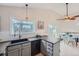 Bright kitchen featuring a modern sink, black appliances, and an adjacent dining area with natural light at 9383 Cobblecrest Dr, Highlands Ranch, CO 80126