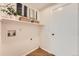 Laundry room with tile floors, white walls, and shelving at 9383 Cobblecrest Dr, Highlands Ranch, CO 80126