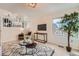 Bright living room featuring a decorative rug, television, and view of the upper level at 9383 Cobblecrest Dr, Highlands Ranch, CO 80126