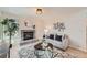 Bright living room featuring brick fireplace, modern decor, and neutral colored walls at 9383 Cobblecrest Dr, Highlands Ranch, CO 80126