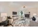 Cozy living room featuring a brick fireplace, decorative rug, and neutral colored walls at 9383 Cobblecrest Dr, Highlands Ranch, CO 80126