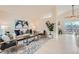 Bright, open-concept living room with white walls, wood floors, a plant, and access to the outdoor deck at 9383 Cobblecrest Dr, Highlands Ranch, CO 80126