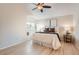 Comfortable main bedroom with a window seat, ceiling fan, and abundant natural light at 9383 Cobblecrest Dr, Highlands Ranch, CO 80126