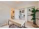 Bright office space with built-in shelves, a wooden desk, and a houseplant creating a welcoming work environment at 9383 Cobblecrest Dr, Highlands Ranch, CO 80126