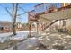 View of the covered patio beneath a deck and stairs, offering an open space for outdoor activities and relaxation at 9383 Cobblecrest Dr, Highlands Ranch, CO 80126