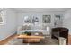 Bright living room featuring a white sofa and wooden coffee table at 2756 S Hooker St, Denver, CO 80236