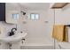 Bathroom featuring white tile, a modern sink, and a shower-tub combination for functionality at 5330 S Windermere St, Littleton, CO 80120