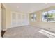 Bright bedroom featuring neutral walls, plush carpet, and ample natural light from large windows at 5330 S Windermere St, Littleton, CO 80120