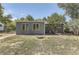 Rear view of the home. Chain link fence and mature trees at 5330 S Windermere St, Littleton, CO 80120