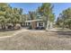 Exterior of a gray house with a walkway and mature trees, providing shade and curb appeal at 5330 S Windermere St, Littleton, CO 80120