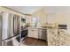 Updated kitchen with stainless steel appliances, granite countertops, and white cabinets at 5330 S Windermere St, Littleton, CO 80120