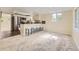 Open-concept living area with a breakfast bar, plush carpet, and stainless steel appliances at 5330 S Windermere St, Littleton, CO 80120