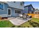 A concrete backyard patio is shown with furniture and a barbecue at 10518 Hyacinth Pl, Highlands Ranch, CO 80129