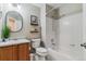A full bathroom features a shower and tub combination and a modern vanity at 10518 Hyacinth Pl, Highlands Ranch, CO 80129