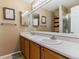Bathroom with double sinks, large mirror, and shower with a glass door at 10518 Hyacinth Pl, Highlands Ranch, CO 80129