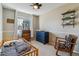 This bedroom has a ceiling fan, a large window, and lots of natural light at 10518 Hyacinth Pl, Highlands Ranch, CO 80129