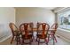 Bright dining room with a large window, wood floors, and a dining table set for a meal at 10518 Hyacinth Pl, Highlands Ranch, CO 80129