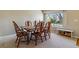 Bright dining room with a large window, wood floors, and a dining table set for a meal at 10518 Hyacinth Pl, Highlands Ranch, CO 80129