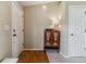 Inviting entryway featuring hardwood floors, a storage cabinet with a lamp, and a white front door at 10518 Hyacinth Pl, Highlands Ranch, CO 80129