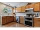 Well-equipped kitchen featuring light wood cabinets and stainless steel appliances at 10518 Hyacinth Pl, Highlands Ranch, CO 80129