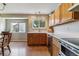 Kitchen with light wood cabinets, stainless steel appliances, and a dining area with view at 10518 Hyacinth Pl, Highlands Ranch, CO 80129