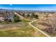 Aerial view of a neighborhood with a walking path, green space, and mountain views at 10518 Hyacinth Pl, Highlands Ranch, CO 80129