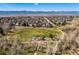 Aerial view of a neighborhood park with a playground, walking path, and mountain views at 10518 Hyacinth Pl, Highlands Ranch, CO 80129