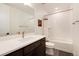 Clean bathroom with white subway tiles and dark vanity at 9203 Star Streak Cir, Littleton, CO 80125