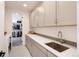 Bright laundry room with plenty of cabinet space and a large sink at 9203 Star Streak Cir, Littleton, CO 80125