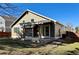 Backyard with patio, privacy fence, mature trees, and grass under a blue sky at 9668 Salem Ct, Highlands Ranch, CO 80130