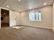 Basement features neutral paint, gray carpet, window, and doorway leading to another room at 9668 Salem Ct, Highlands Ranch, CO 80130