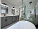 Primary bathroom with double vanity, modern fixtures, frameless shower, and tub at 9668 Salem Ct, Highlands Ranch, CO 80130