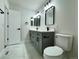 Bright bathroom with gray vanity, dual sinks, modern fixtures, and tiled floor at 9668 Salem Ct, Highlands Ranch, CO 80130