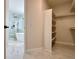Walk-in closet with built-in shelving and a view into the primary bathroom at 9668 Salem Ct, Highlands Ranch, CO 80130