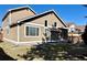 Exterior view of tan two story home features a covered patio and green lawn at 9668 Salem Ct, Highlands Ranch, CO 80130